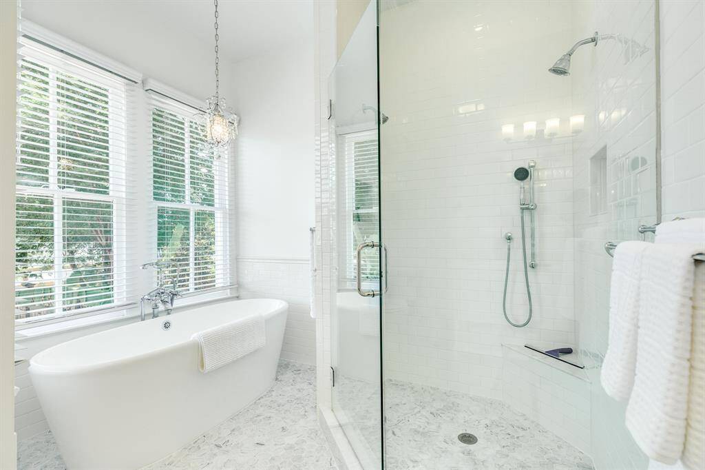 Pedestal Tub and Marble floors and spacious shower for first floor Primary bedroom