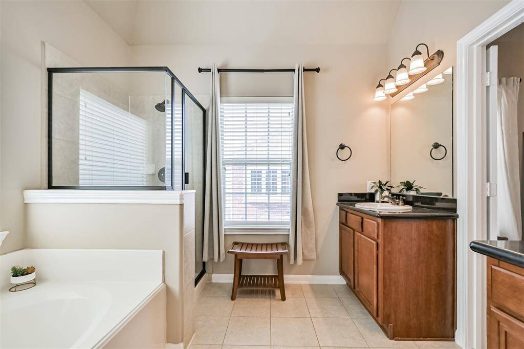 Separate bath and oversized shower with step.