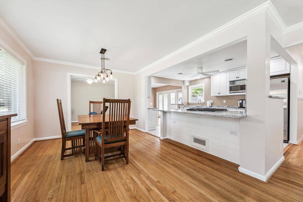 Dining area just off the kitchen with office space in background