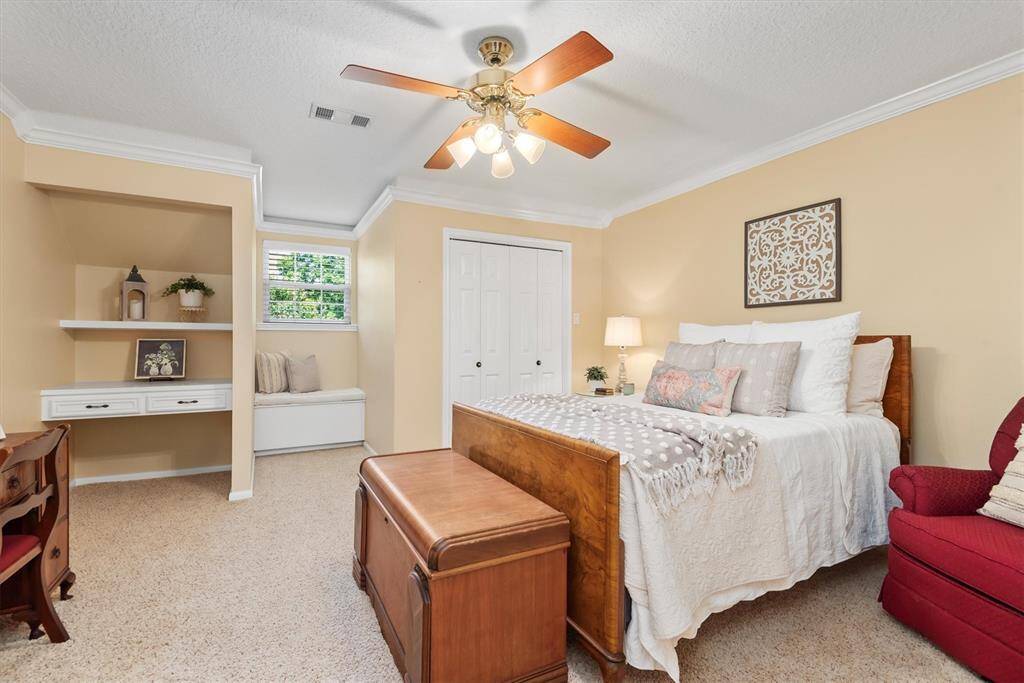 Upstairs Bedroom 2 - Another spacious secondary bedroom with built-in shelving and desk area, perfect for a guest suite, hobby room, or home office setup. The built in desk, shelves and window seat are fabulous features.