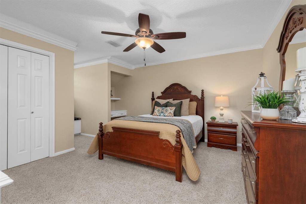 Upstairs Bedroom 3 - Guest Suite with ensuite bathroom - This bright and comfortable bedroom features plush carpet, built-in storage/desk, window seat, and ample space for furniture.