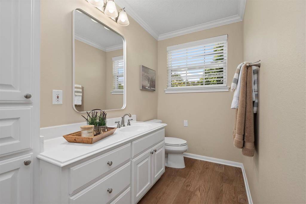 Upstairs Beth 2 - Private ensuite bath for upstairs bedroom 3 - featuring a spacious vanity, framed mirror, and shower/tub combo.