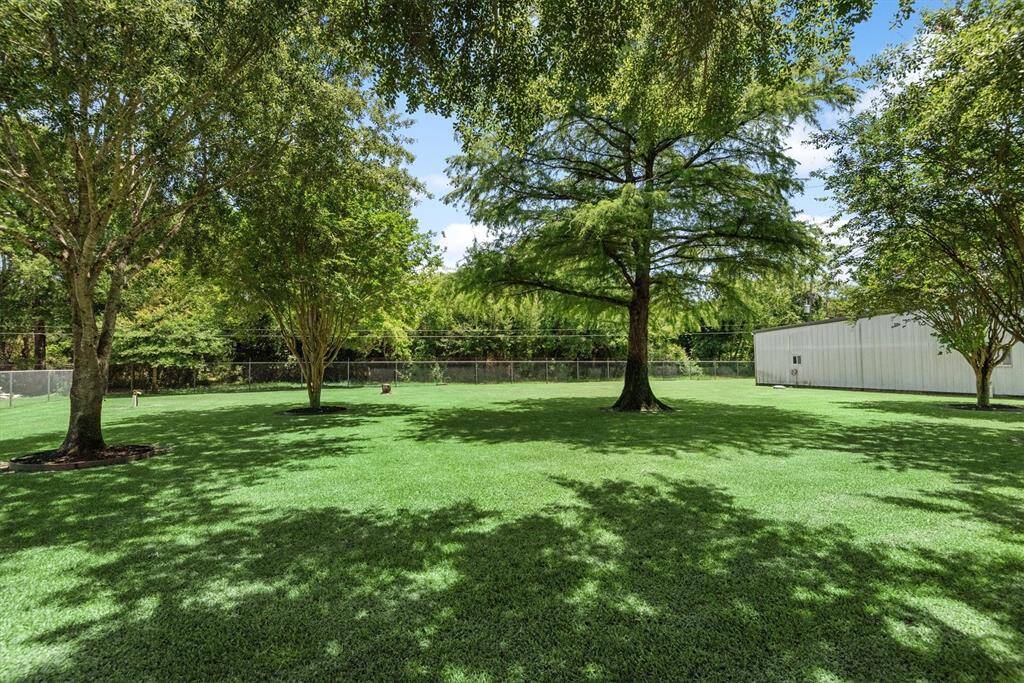 Take a look at this park-like setting! This backyard features mature trees, open green space, and plenty of room for outdoor activities, gardening, or additional "play area"—fully fenced for privacy and peace of mind.
