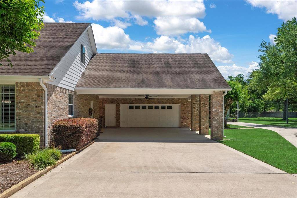 You won't run out of parking space with this oversized covered driveway with easy access to the detached two-car garage—offering plenty of space for parking, storage, or outdoor projects. There is also additional storage space  located in the ceiling of the carport.