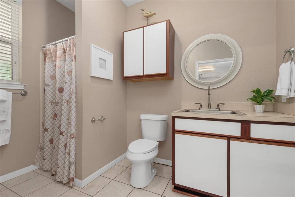 Detached garage full bathroom with shower—perfectly positioned for easy access from the pool, backyard, or workshop projects.