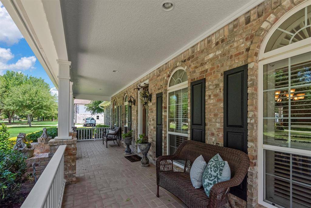 Enjoy peaceful mornings or relaxing evenings on the spacious front porch with classic brick detail and scenic views of the front yard.