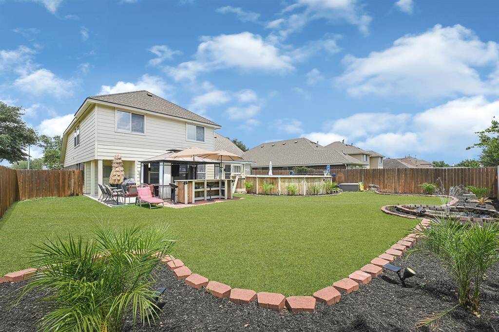 Expansive backyard with stunning landscaping.