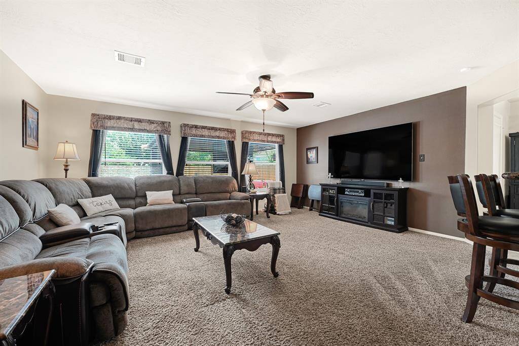 Spacious living room with abundant natural light, perfect for relaxation and entertainment.