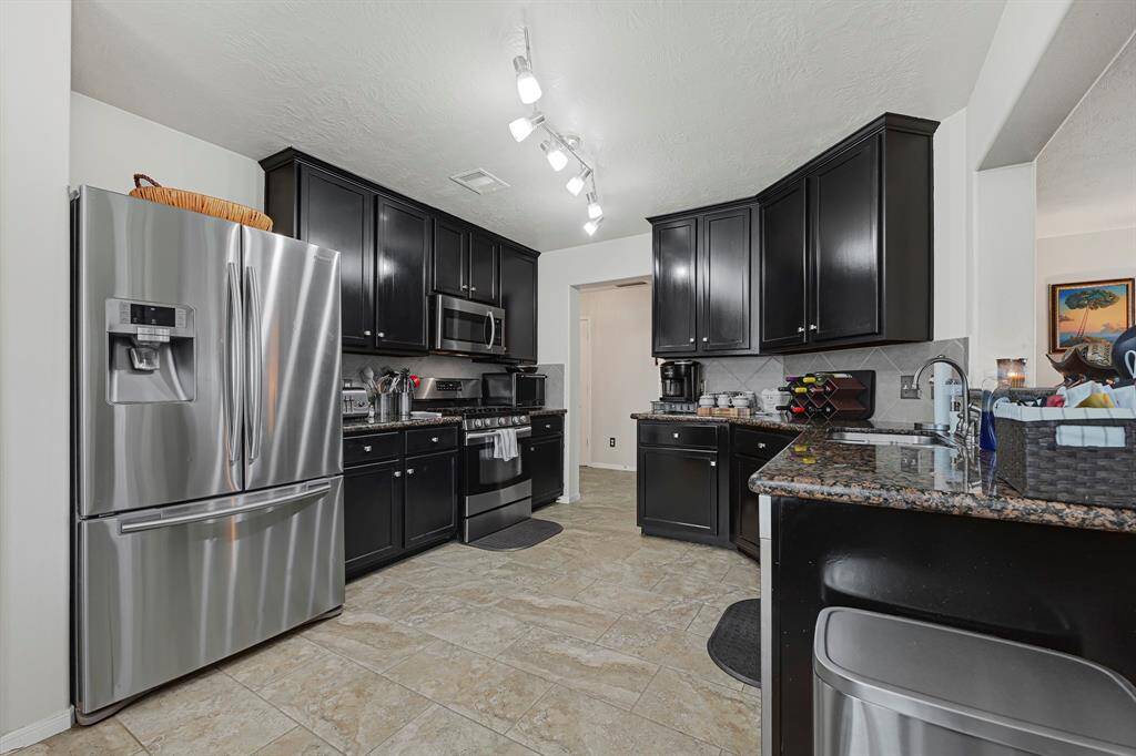 Spacious kitchen with ample natural light, and modern cabinetry. Perfect for hosting and everyday living.
