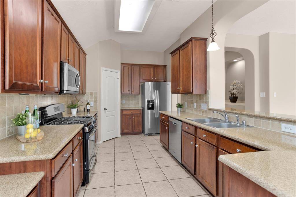 The kitchen is a chef's dream, tons of counterspace and cabinets, s/s appliances and even a workspace/desk