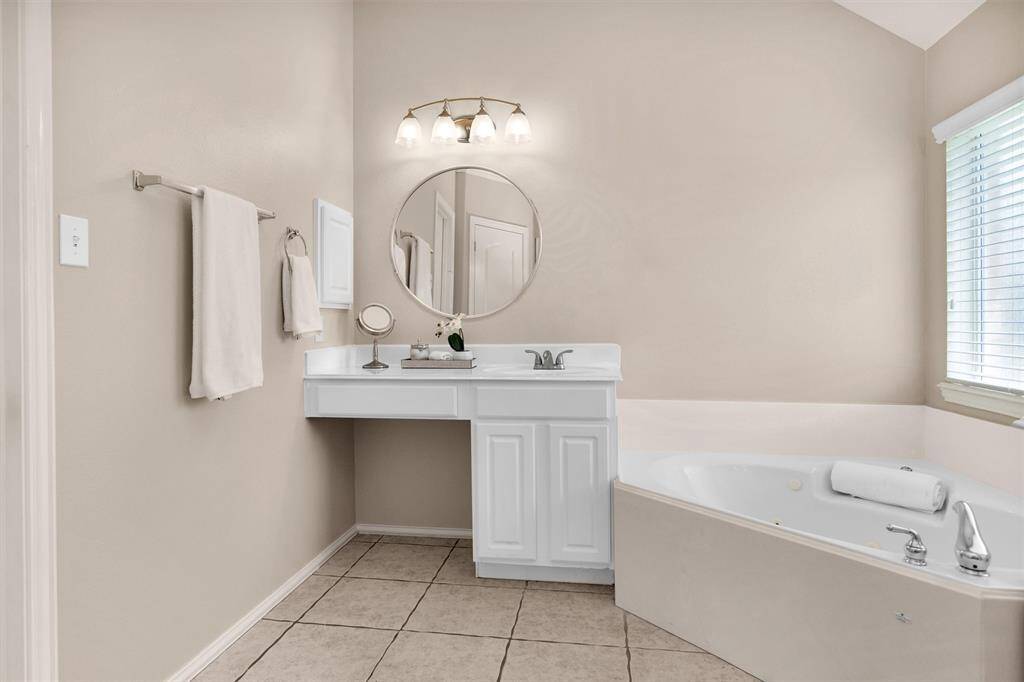 Stylish vanity thoughtfully placed next to the expansive  tub