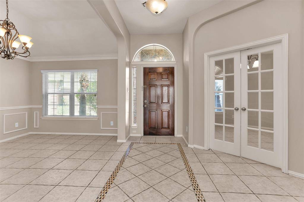 As seen from the expansive entryway, dining on the left, study on the right