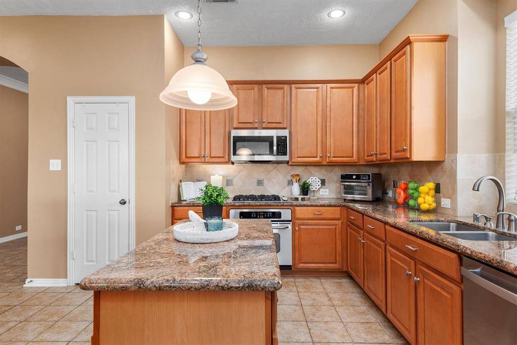 This kitchen has an abundance of counter and cabinet space.  It's a perfect space for all to gather and prepare meals.