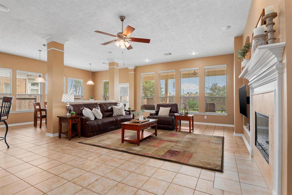 The windows surrounding the breakfast room and living room bring the outdoors in and create a bright and serene atmosphere.