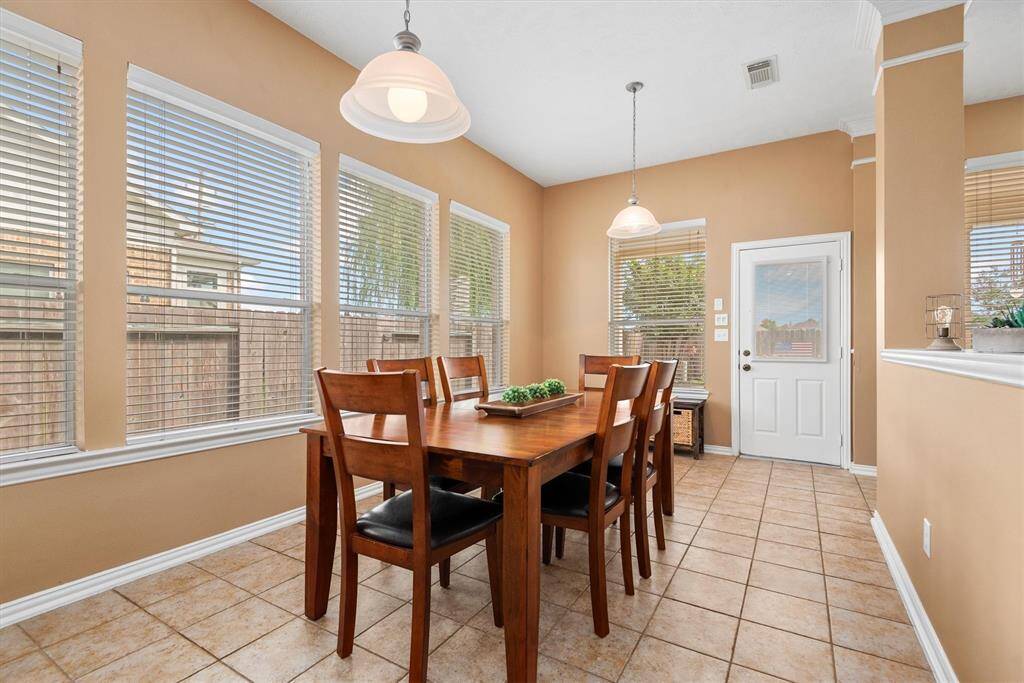 A sitting area could easily be incorporated into the breakfast room.  The wall of windows bring in so much natural light here also.