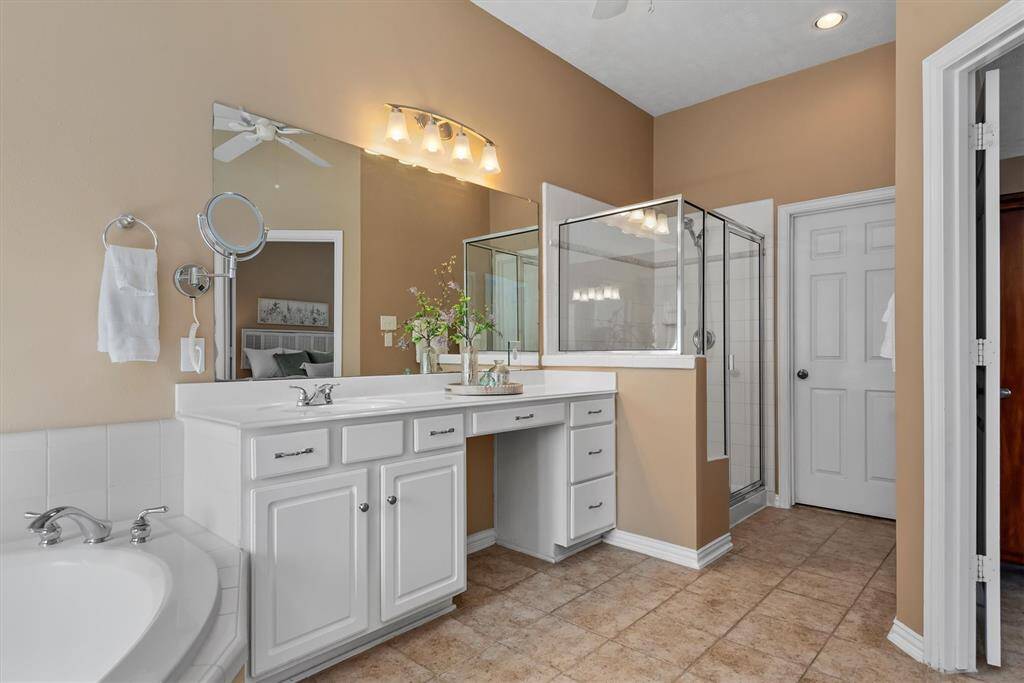 The dual vanities offer plenty of space for morning routines and extra storage- perfect for shared spaces.