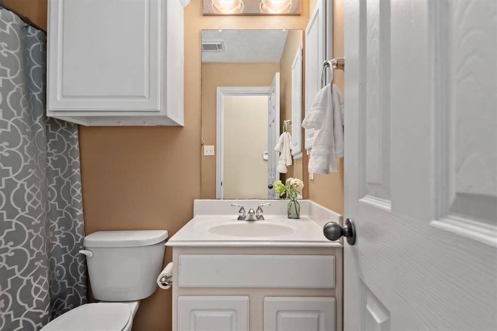The first of 2 secondary bathrooms is located in the hallway just outside secondary bedroom one.