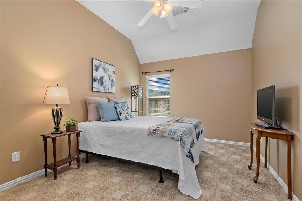 Secondary bedroom 3 has a vaulted ceiling as well and a large walk in closet.