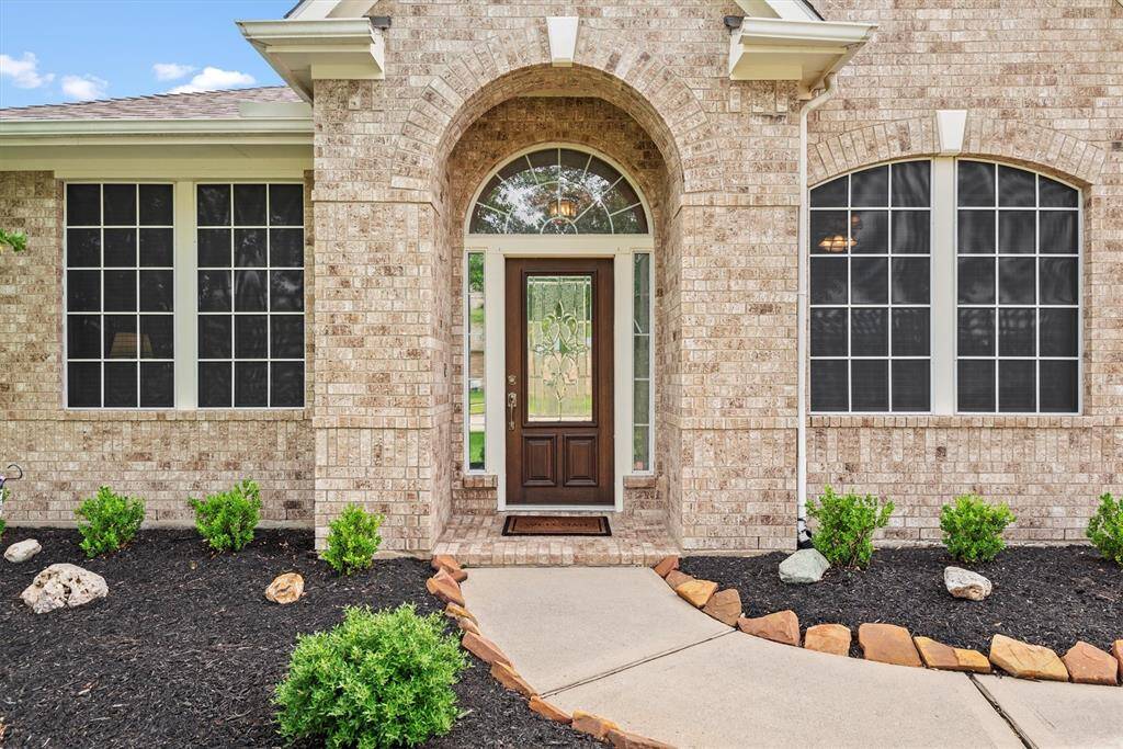 Beautifully manicured landscaping and charming curb appeal set the tone as you walk up to the front door.