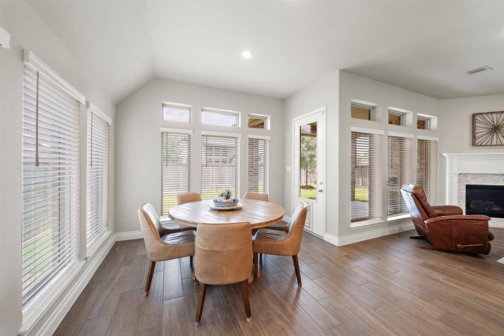 The spacious dining area is perfect for gathering around a large table, surrounded by windows that fill the space with natural light and create the perfect setting for memorable meals.