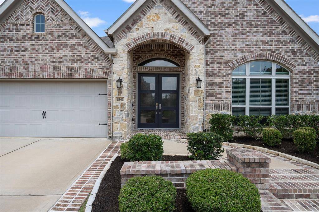 Elegant double front doors make a bold first impression.