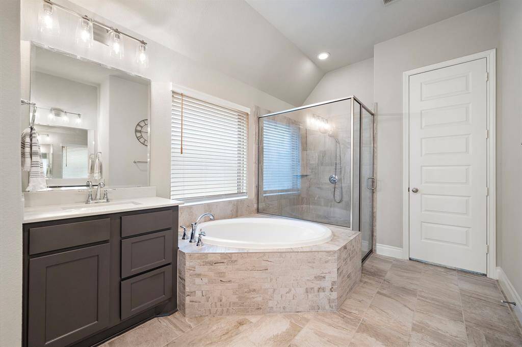 The en suite bath is a true retreat with dual vanities and a corner soaking tub.