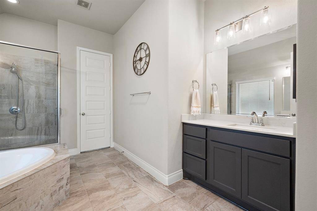 A glass-enclosed shower, and a spacious walk-in closet.