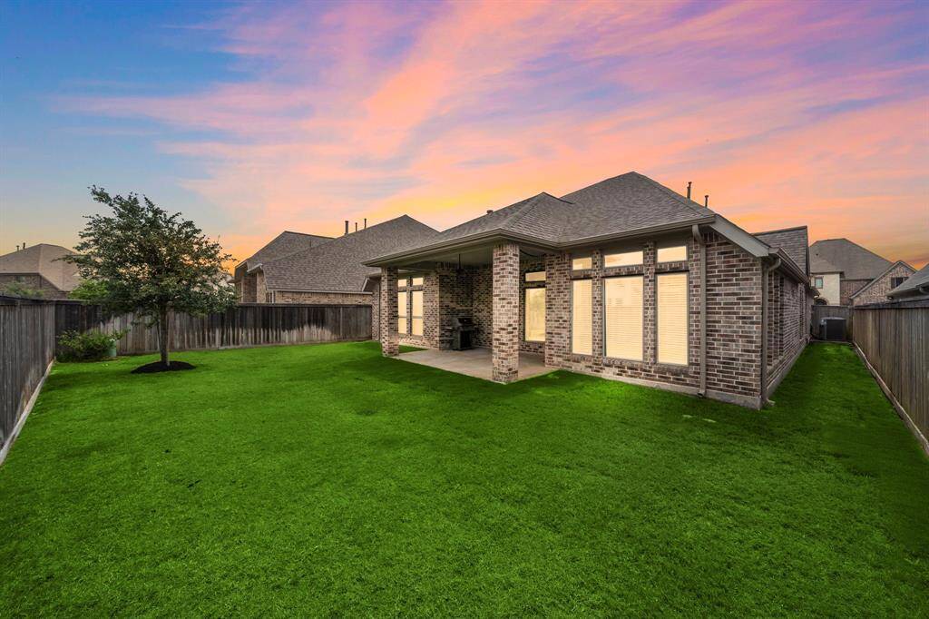 Extended covered back patio—the perfect setting for morning coffee, evening wine, or weekend BBQs.