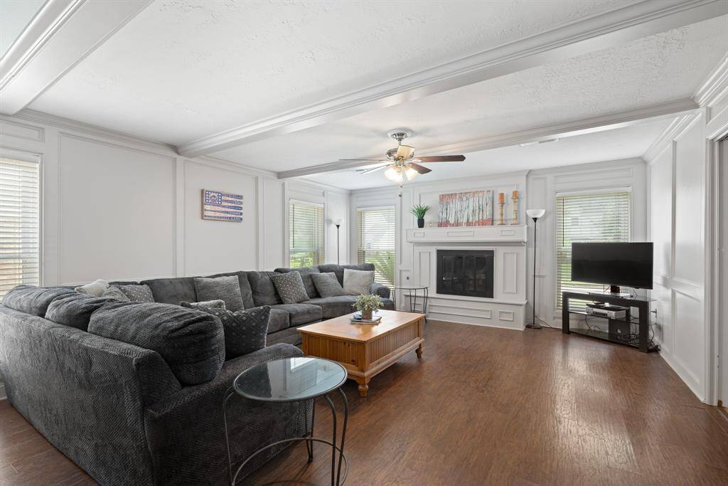 FAMILY ROOM - Fireplace with gas logs gives this room a cozy feel.  The large windows let in lots of natural light.
