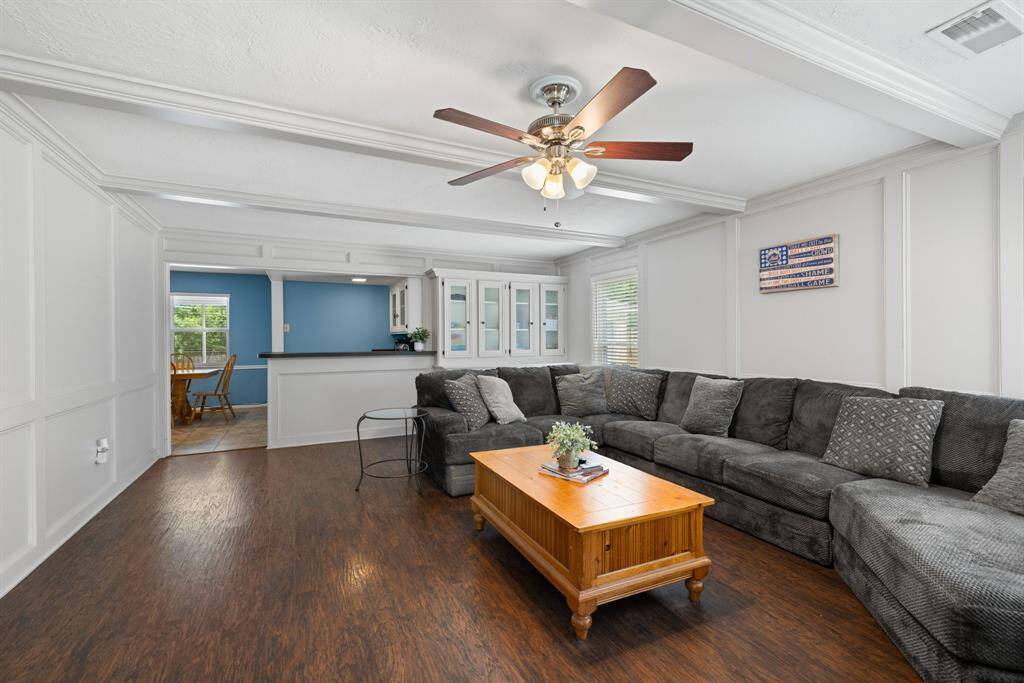 FAMILY ROOM - Towards the back of the family room are built in cabinets and bookcases, along with a spacious wet bar area.