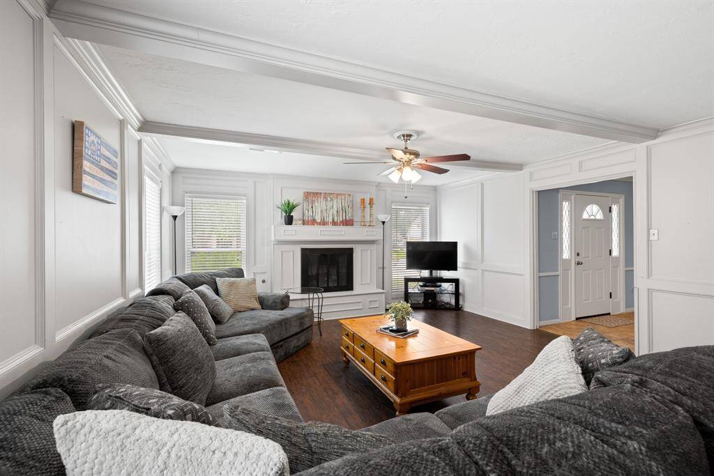 FAMILY ROOM - The white painted paneling and light gray beams in the ceiling give this room a very updated, yet traditional feel.