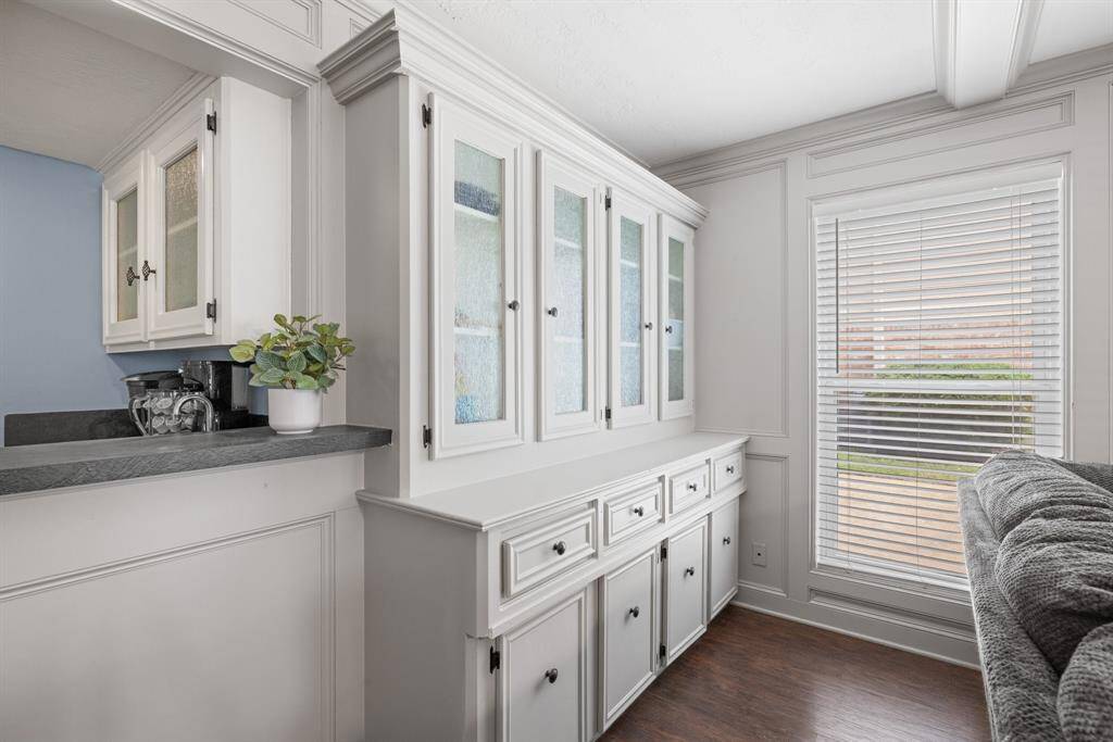 FAMILY ROOM - Nice built-in cabinets, drawers and bookcases for extra storage and showcasing decorative items.