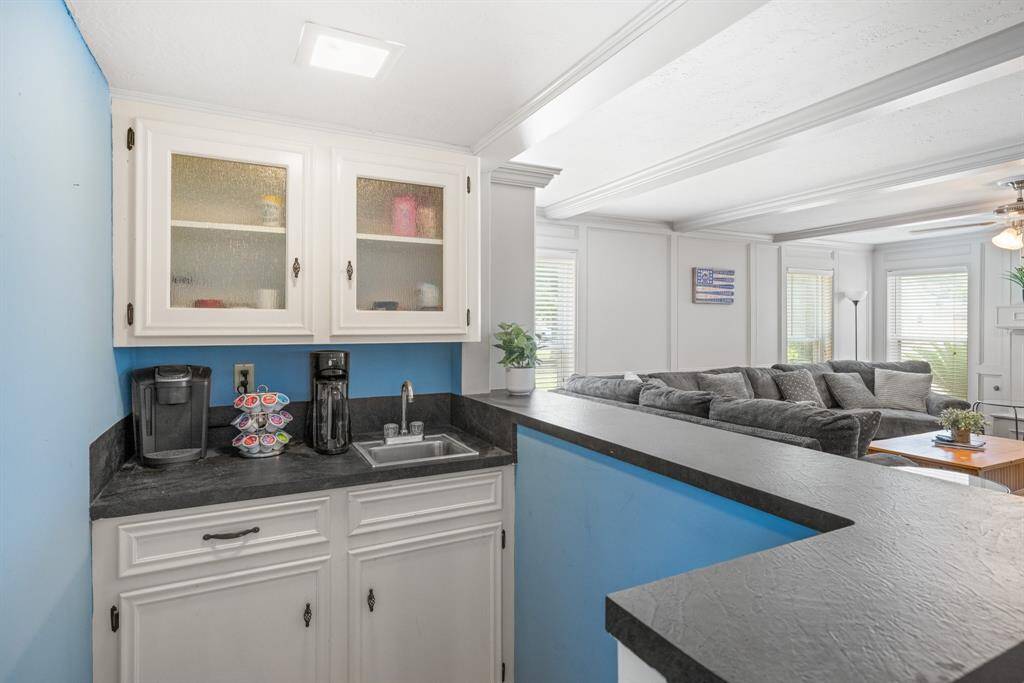 WET BAR - This wet bar is useful and can serve as a coffee bar and serving area for guests.  It also has extra storage cabinets and pretty glass front cabinets above.
