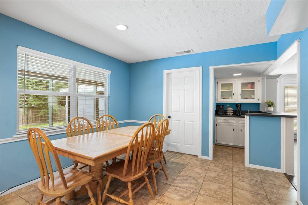 BREAKFAST ROOM - View out the window is to the large, screened patio and back yard.  The doorway leads to the utility room & powder room.