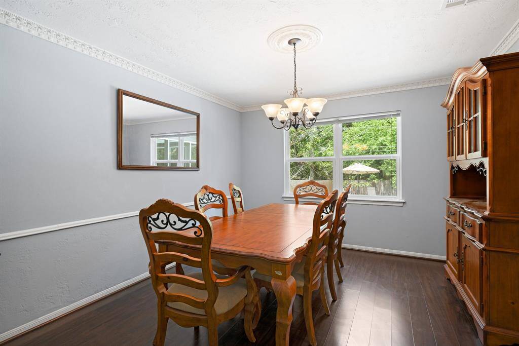 DINING ROOM - Spacious dining room can accommodate the table & hutch.   It also has a great view of the back yard.