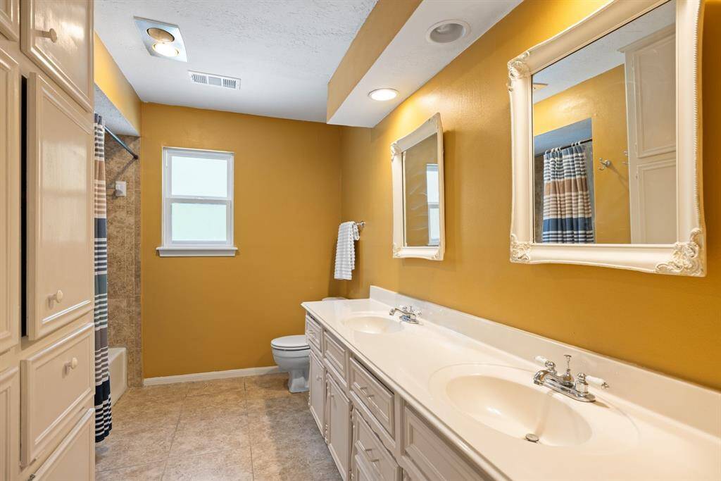PRIMARY BATHROOM - Double sinks and lots of storage space under sinks and on the opposite side of the bathroom.
