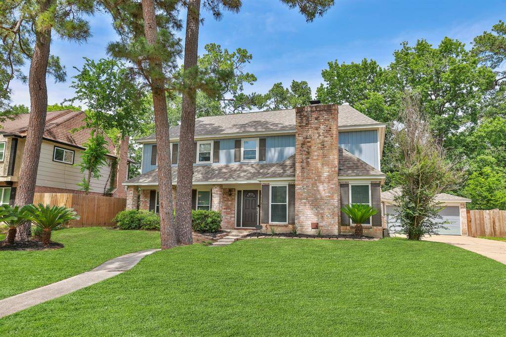 Nice curb appeal with mature trees and flower beds already in place.