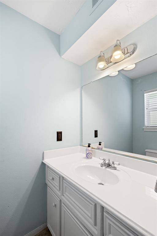 DOWNSTAIRS POWDER ROOM - Located off utility room.  It's very convenient for coming in from the pool.  No need to walk across the house to come into the bathroom.  It is conveniently located by the back porch.