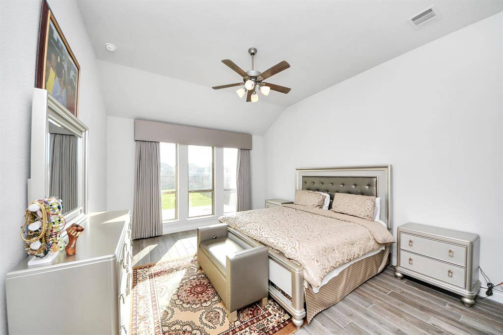 The high ceilings and natural light continue to the primary bedroom.