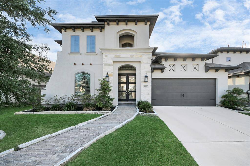 The brick walkway and double front doors elevate the look of the home!
