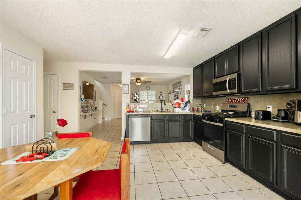 Equipped with stainless steel appliances and a pantry, this kitchen blends style and practicality to support all your cooking needs.