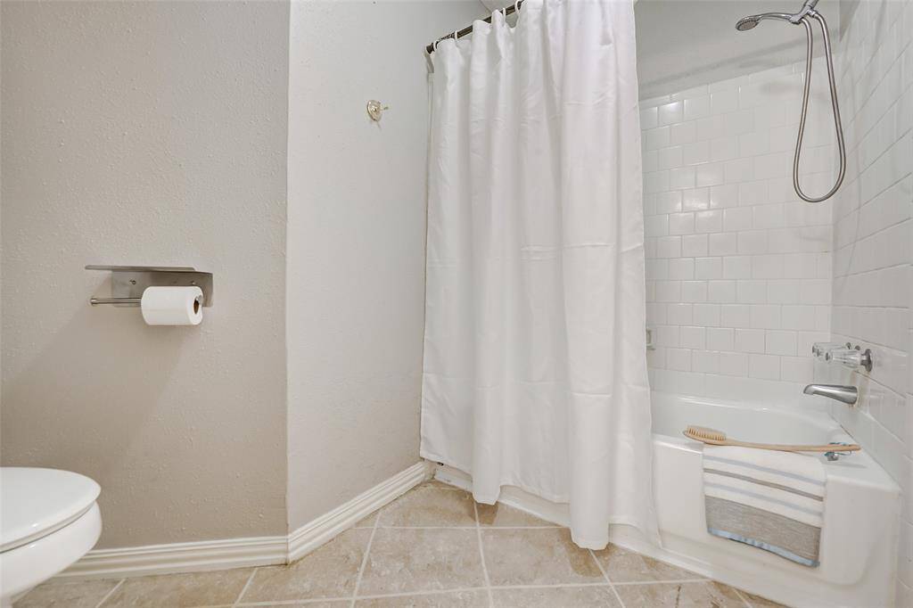 This primary bathroom features a bathtub and shower combo.