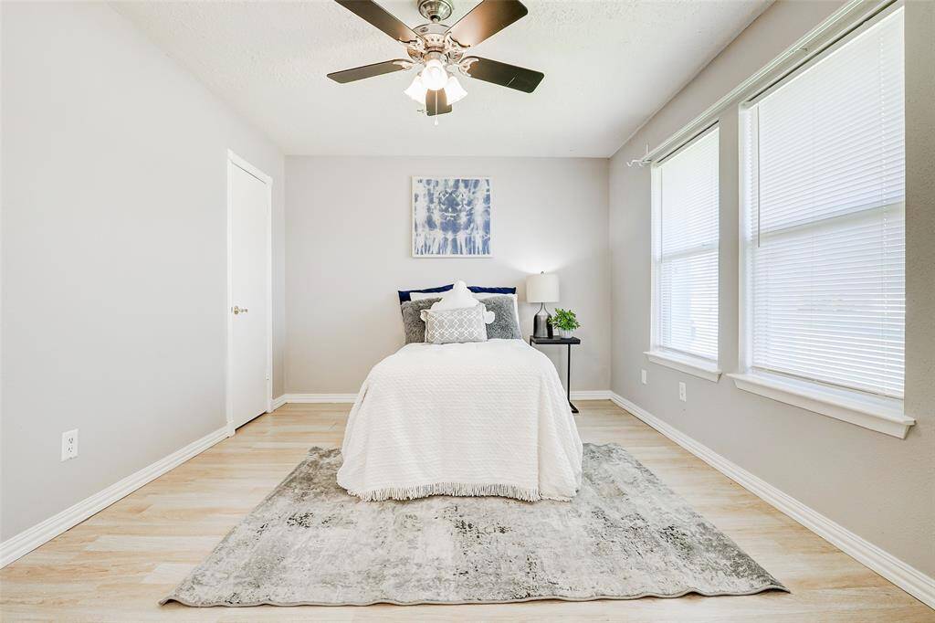 This bedroom is located at the front of the home, to the right of the front door. Two large windows provide ample natural light, a ceiling fan adds comfort, and a large walk-in closet is perfect for all your clothes and shoes.