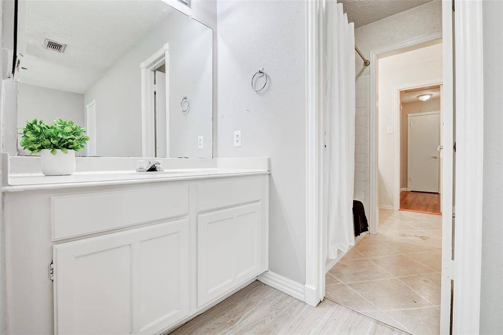 Private vanity in the front bedroom. The door leads to the tub/shower combo and toilet area.