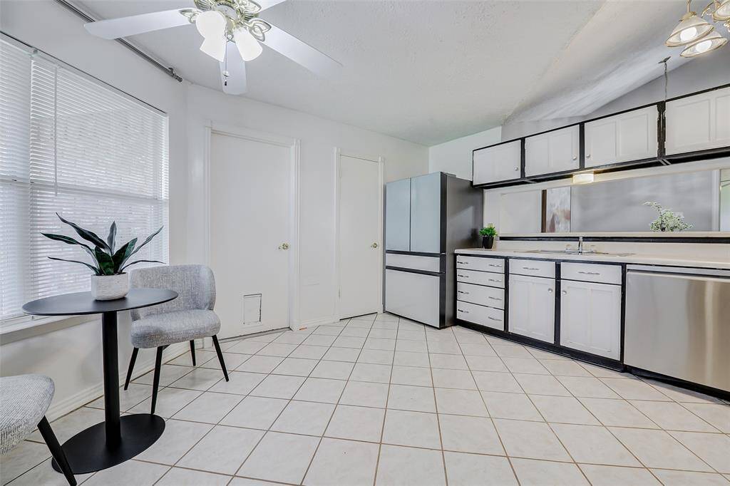 Bright kitchen with modern stainless steel appliances, ample cabinet space, and a cozy breakfast nook by the window. Ideal for comfortable living and entertaining.