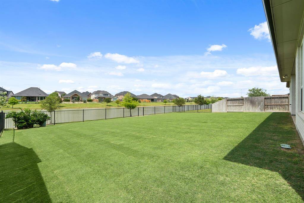Relax and enjoy stunning lake views  from the comfort of your backyard. A  wrought iron fence provides  unobstructed sightlines, allowing you  to fully take in the serene waterfront  setting