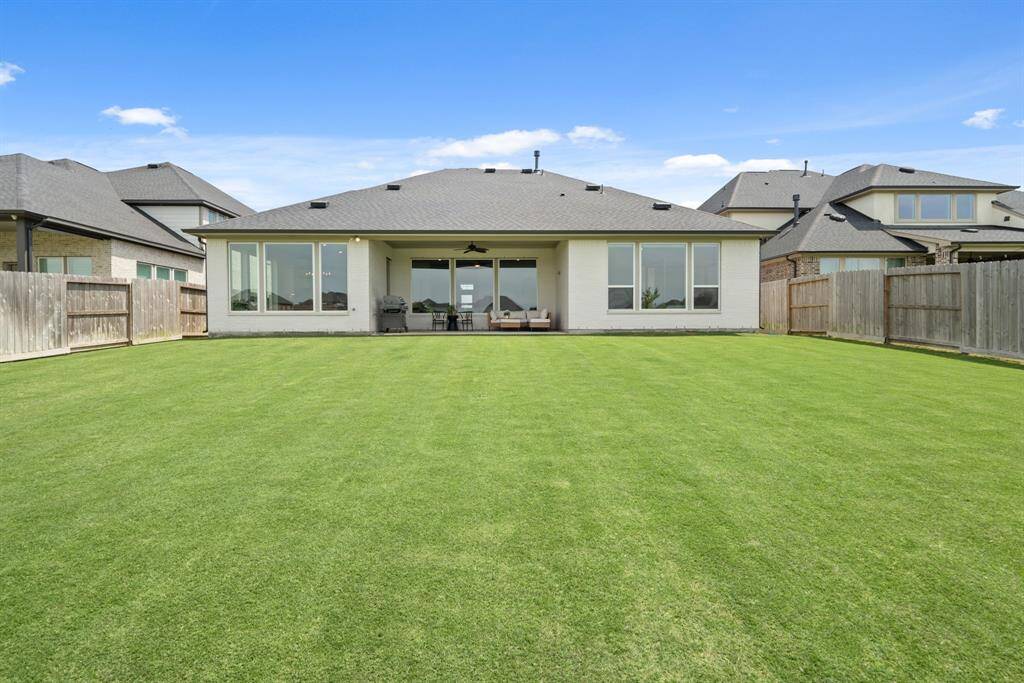 Relax and enjoy stunning lake views  from the comfort of your backyard. A  wrought iron fence provides  unobstructed sightlines, allowing you  to fully take in the serene waterfront  setting