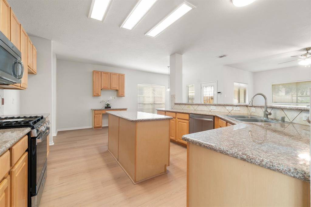 Kitchen opens to living room and breakfast area