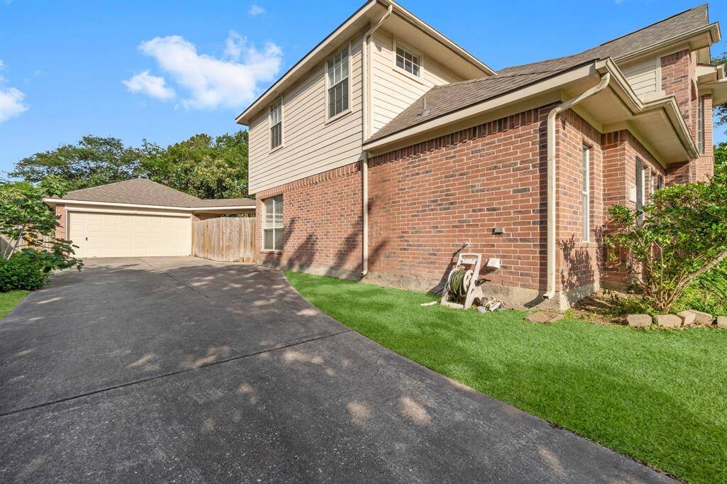 Long drive way leads to detached garage