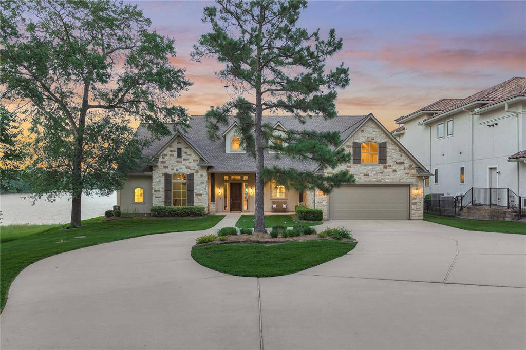 Attractive stone and stucco exterior with cedar wrapped columns and shutters.
